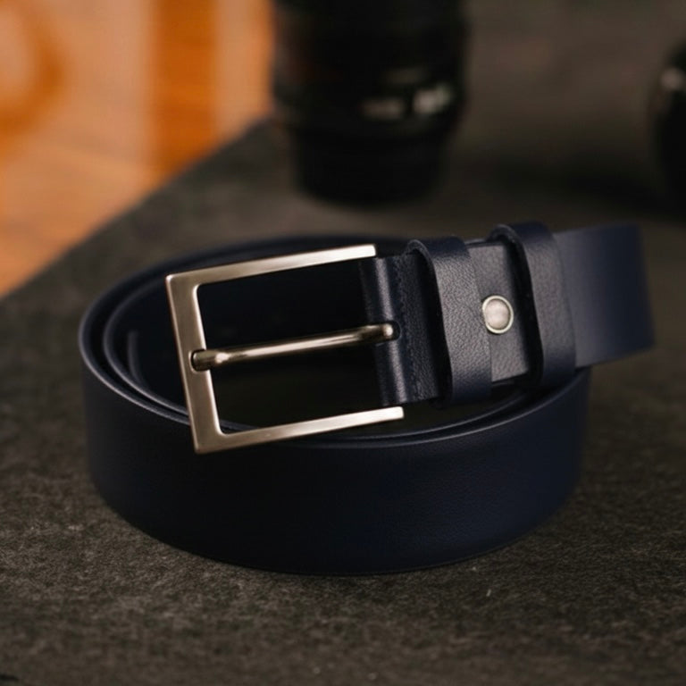 Navy blue leather belt with silver buckle on a dark surface